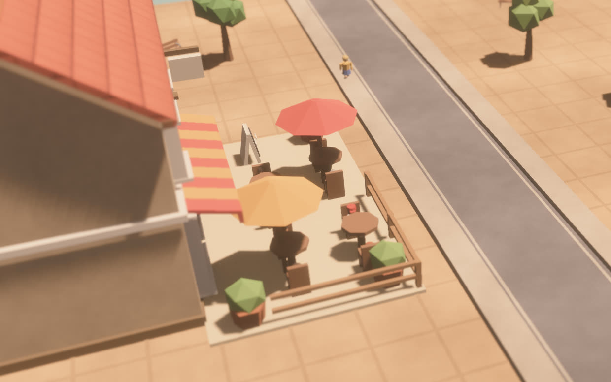 A corner café with red and orange parasols on a paved square